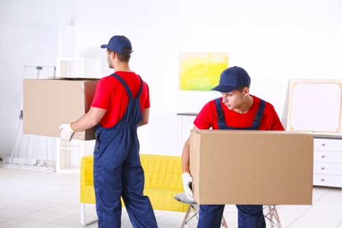 Removal team loading furniture into a van during a UK house move
