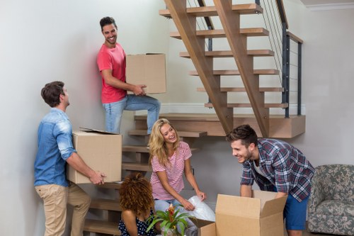 Cardboard boxes and wrapped furniture prepared for a local house move