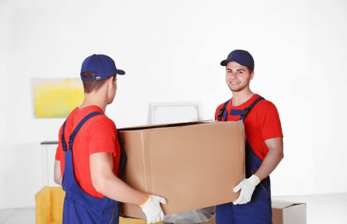 Local movers packing fragile household belongings in South London