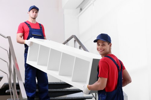 Worker using moving equipment to handle furniture safely