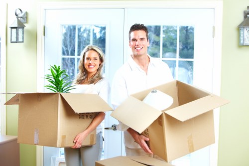 Team carrying furniture from a flat in South London